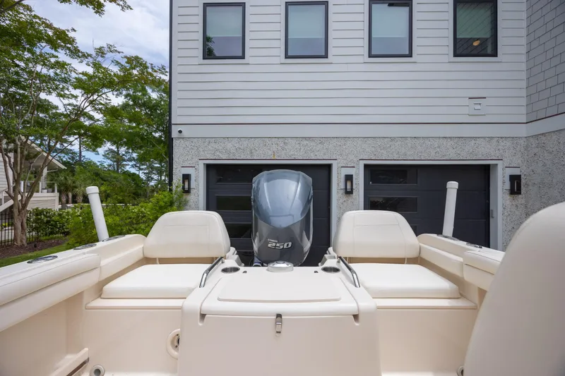 Slide: The Image of 2018 Grady-White Freedom 215 boat with Yamaha 250 engine, parked near modern house. - 10