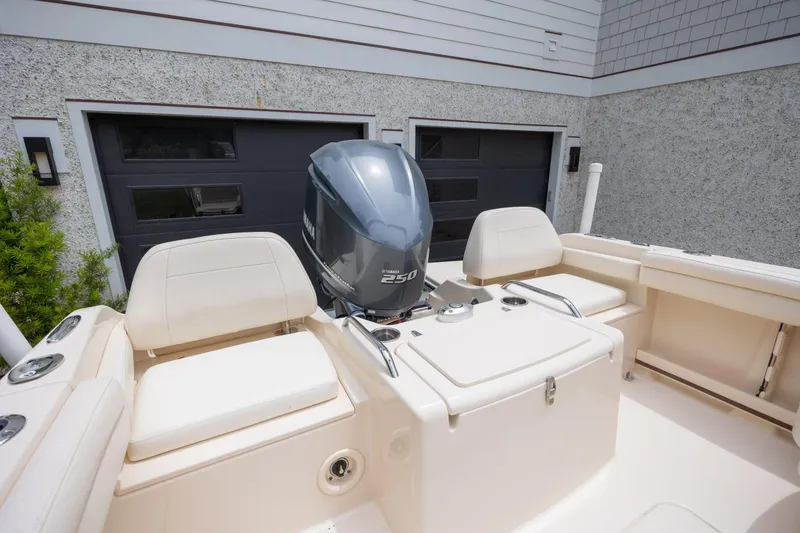 Slide: The Image of 2018 Grady-White Freedom 215 boat with Yamaha 250 engine, parked near garage. - 11