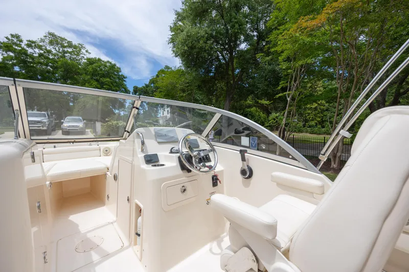 Slide: The Image of 2018 Grady-White Freedom 215 boat interior with steering wheel and seating. - 15