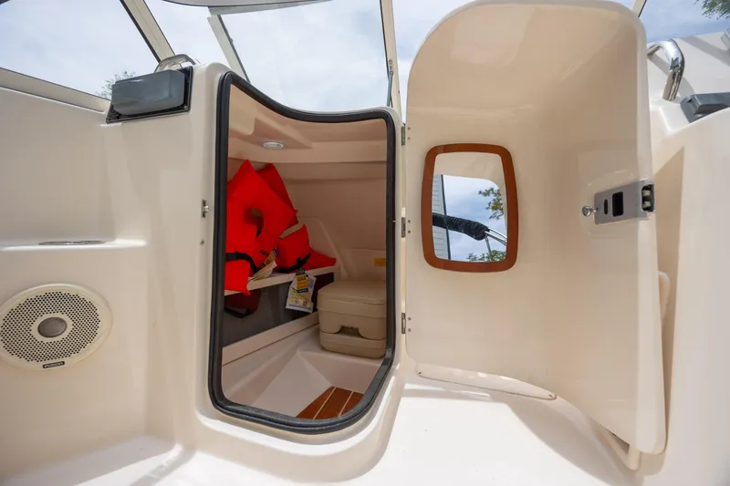 Slide: The Image of 2018 Grady-White Freedom 215 boat interior with life jackets and storage compartment. - 19