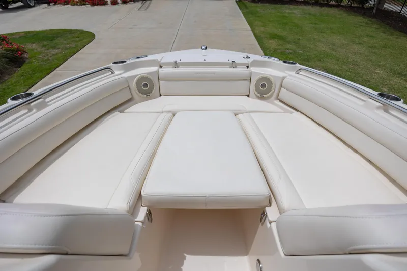 Slide: The Image of 2018 Grady-White Freedom 215 boat interior with white cushioned seating and cup holders. - 21