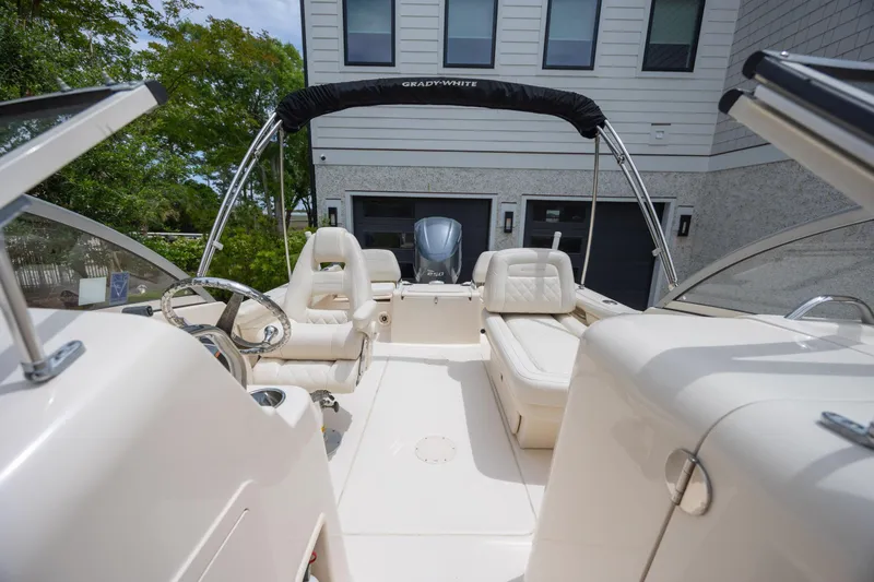 Slide: The Image of 2018 Grady-White Freedom 215 boat interior with seating and steering wheel. - 22