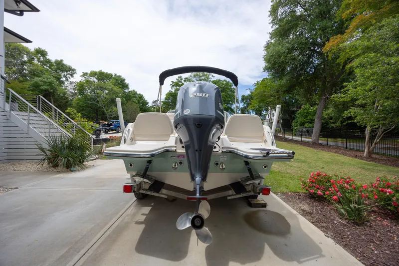 Slide: The Image of 2018 Grady-White Freedom 215 boat with powerful outboard motor, parked on driveway. - 4