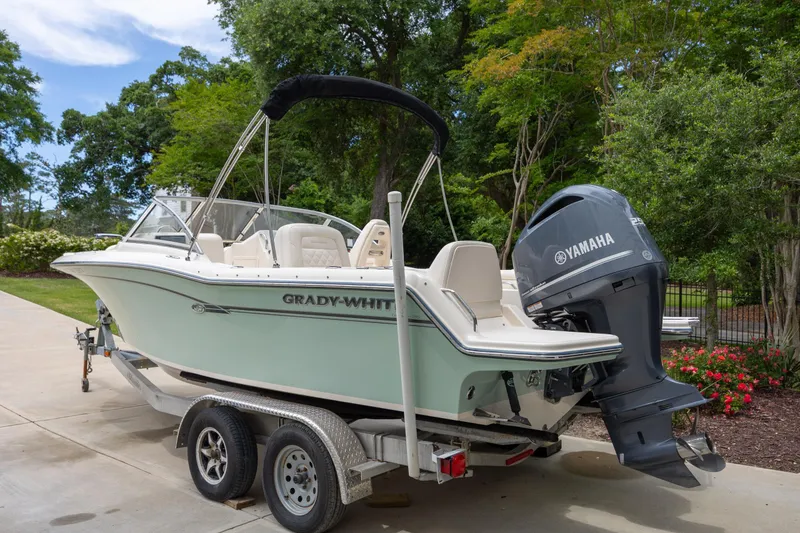 Slide: The Image of 2018 Grady-White Freedom 215 boat on trailer with Yamaha engine, parked outdoors. - 5