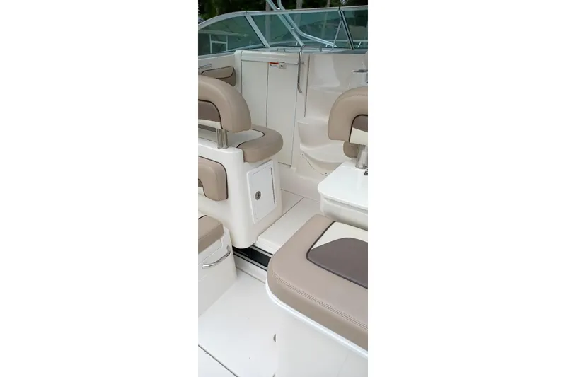 Slide: The Image of 2004 Wellcraft 290 Coastal boat interior with beige seating and white deck. - 10