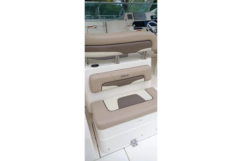 Slide: The Image of 2004 Wellcraft 290 Coastal boat interior with beige seating and helm station. - 11