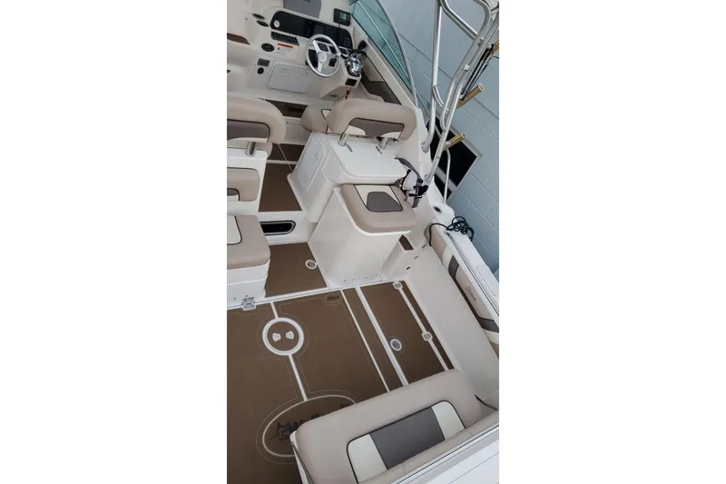 Slide: The Image of 2004 Wellcraft 290 Coastal boat interior with beige seating and modern dashboard. - 12
