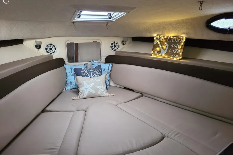 Slide: The Image of Cozy interior of 2004 Wellcraft 290 Coastal boat with nautical-themed decor. - 16