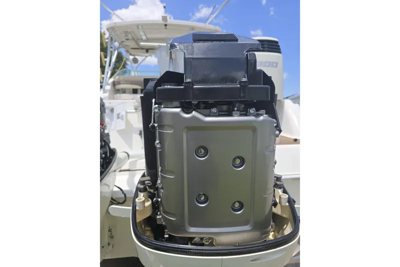 Slide: The Image of 2004 Wellcraft 290 Coastal boat engine close-up under a clear blue sky. - 25