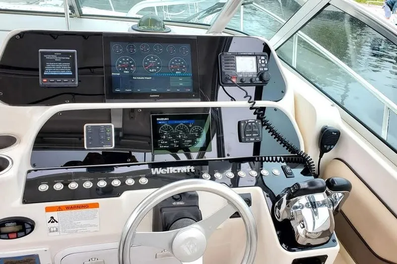 Slide: The Image of Helm of 2004 Wellcraft 290 Coastal boat with modern navigation instruments and controls. - 7