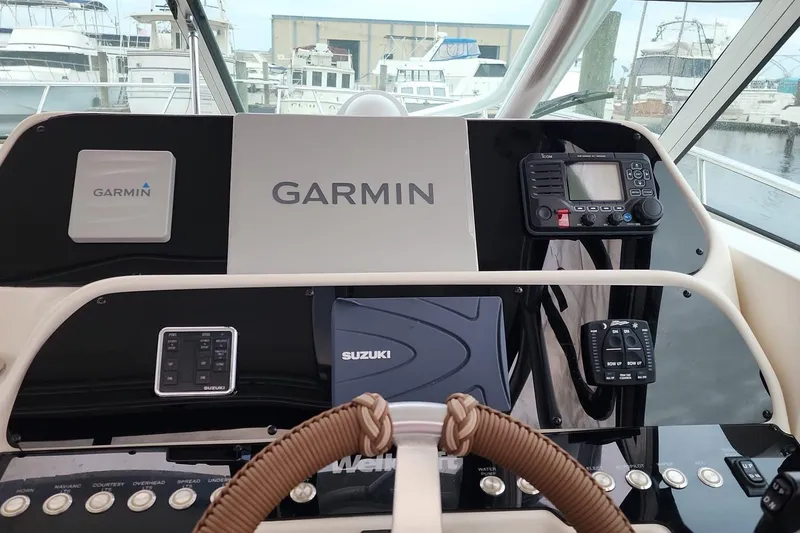Slide: The Image of Dashboard of a 2004 Wellcraft 290 Coastal boat with Garmin and Suzuki equipment. - 8
