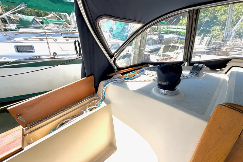 Slide: The Image of Interior view of a 1992 Island Packet 29 sailboat cockpit with winch and ropes. - 12