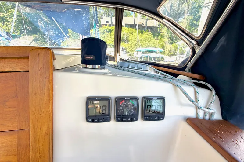 Slide: The Image of Cockpit instruments on a 1992 Island Packet 29 sailboat, featuring navigation displays and ropes. - 14