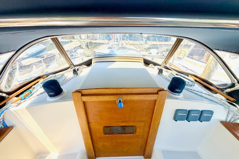 Slide: The Image of Interior view of a 1992 Island Packet 29 sailboat cockpit with wooden hatch and navigation equipment. - 15