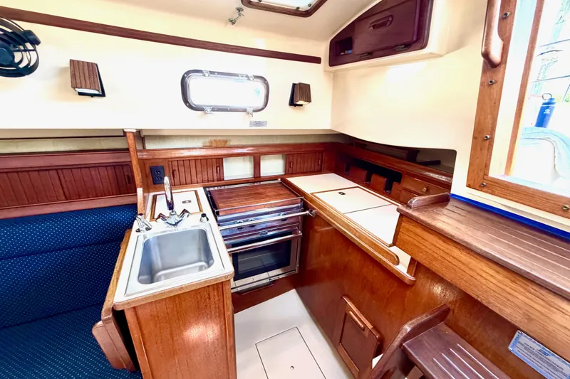 Slide: The Image of Interior of 1992 Island Packet 29 sailboat galley with sink and stove. - 19