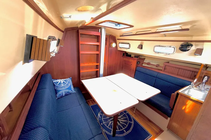 Slide: The Image of Interior of a 1992 Island Packet 29 sailboat with cozy seating and dining area. - 27