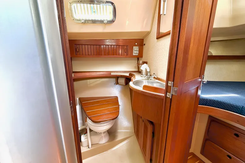 Slide: The Image of 1992 Island Packet 29 yacht bathroom with wooden cabinetry and compact sink. - 31