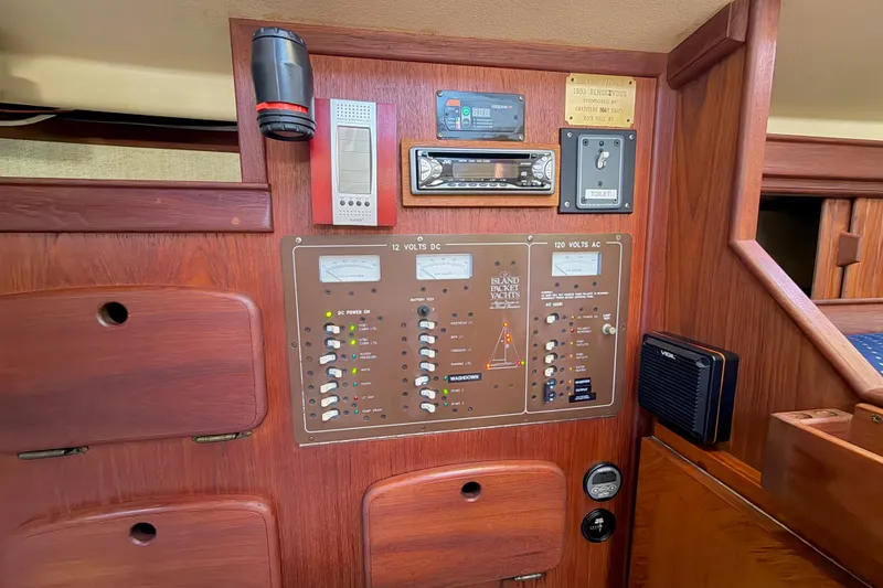 Slide: The Image of Control panel of a 1992 Island Packet 29 yacht with various switches and gauges. - 32
