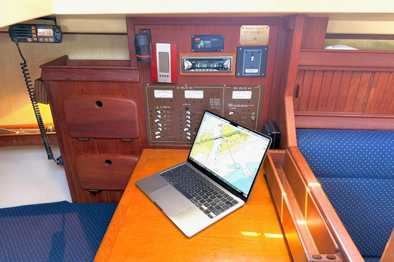 Slide: The Image of Navigation station on 1992 Island Packet 29 sailboat with laptop displaying nautical chart. - 33