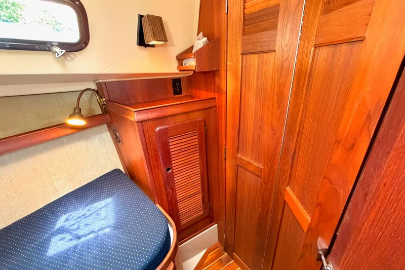 Slide: The Image of Cozy cabin interior of 1992 Island Packet 29 sailboat with wooden cabinetry and seating. - 40