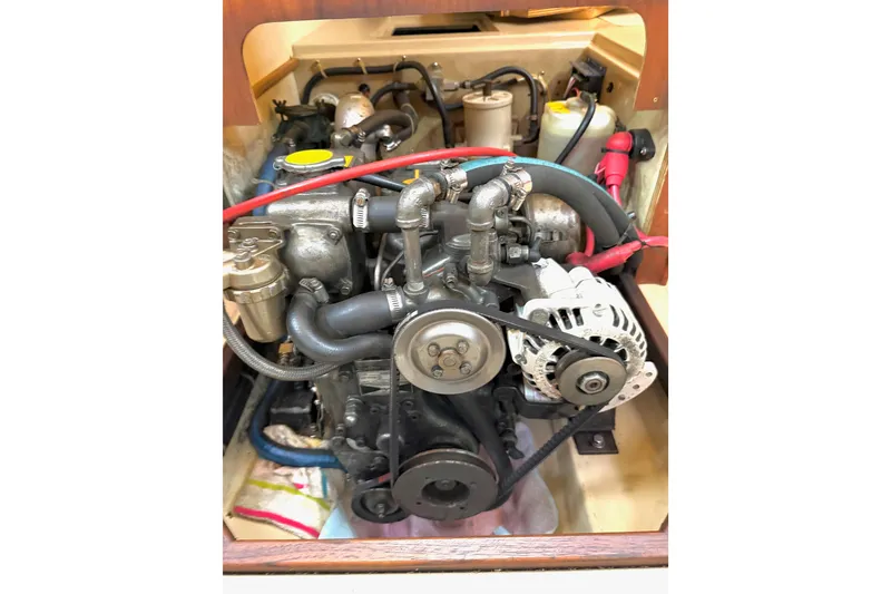 Slide: The Image of Engine compartment of a 1992 Island Packet 29 sailboat, showcasing mechanical components. - 42