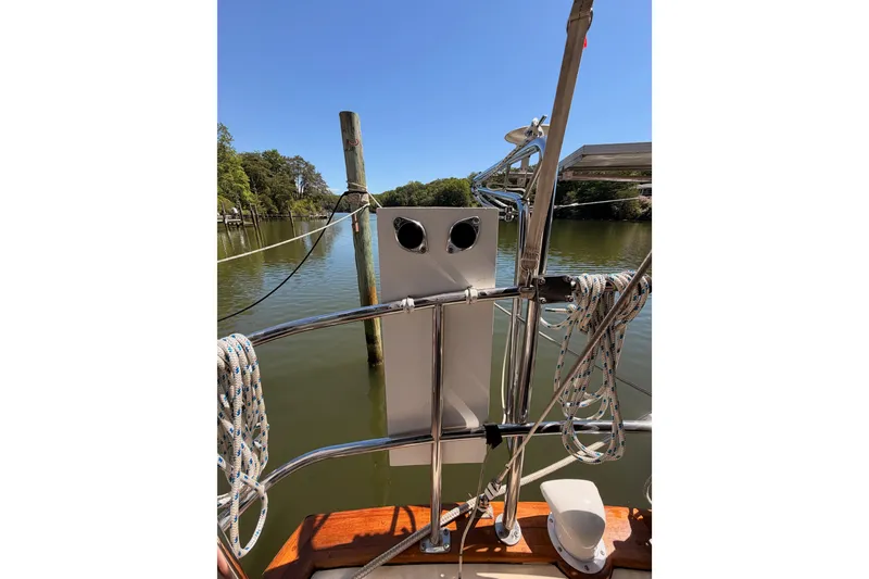 Slide: The Image of 1992 Island Packet 29 sailboat deck with ropes and water view. - 43