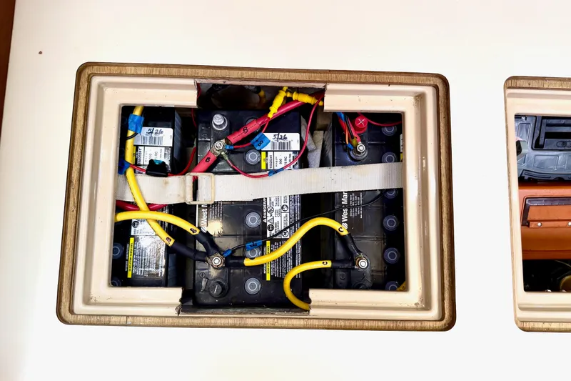 Slide: The Image of Battery compartment of a 1992 Island Packet 29 sailboat, showing wiring and connections. - 44