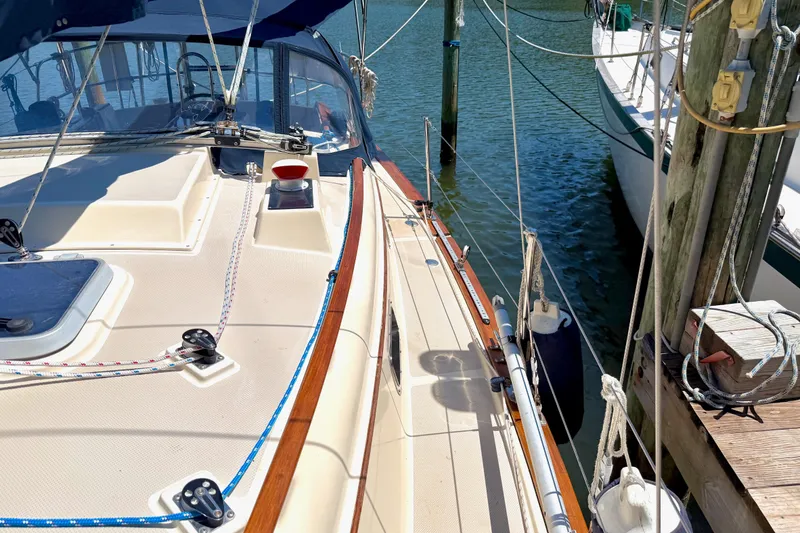 Slide: The Image of 1992 Island Packet 29 sailboat docked, showcasing deck details and rigging. - 6