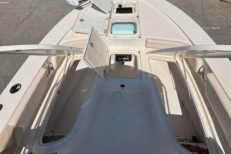 Slide: The Image of 2015 Robalo 246 Cayman boat deck with open storage compartments. - 10