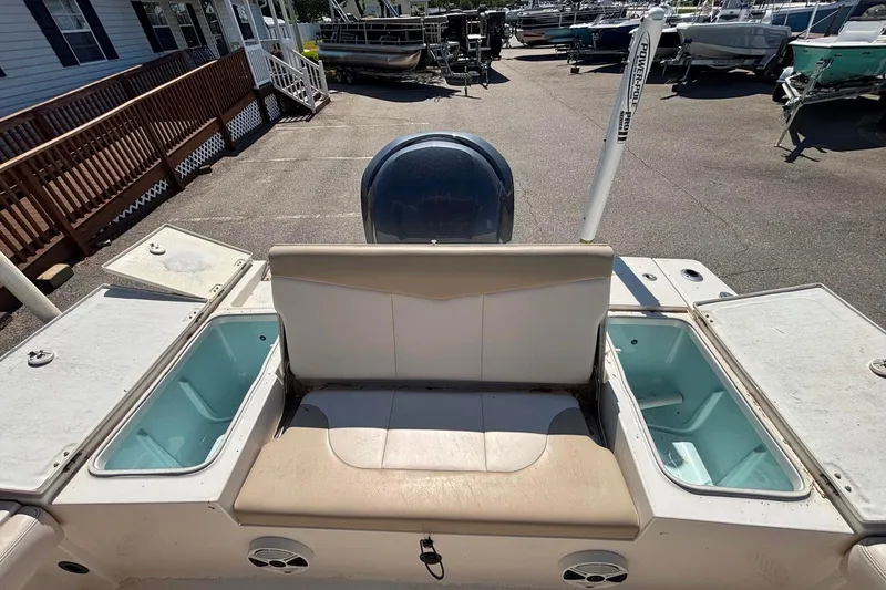Slide: The Image of 2015 Robalo 246 Cayman boat interior with seating and storage compartments. - 15