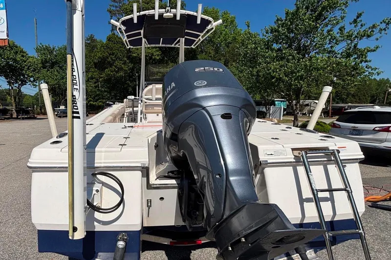 Slide: The Image of 2015 Robalo 246 Cayman boat with Yamaha 250 engine, parked outdoors. - 16