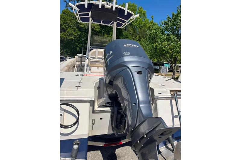 Slide: The Image of 2015 Robalo 246 Cayman boat with Yamaha 250 engine, docked outdoors. - 17