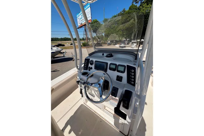 Slide: The Image of 2015 Robalo 246 Cayman boat console with steering wheel and control panel. - 6