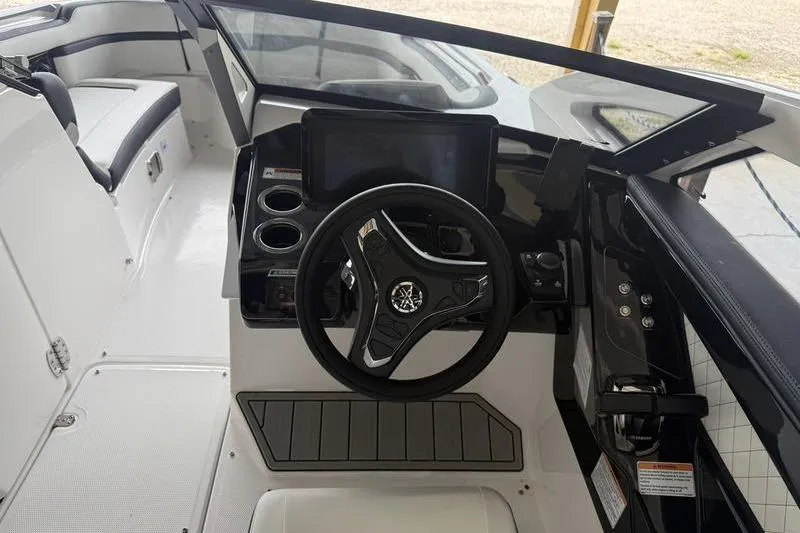 Slide: The Image of 2026 Yamaha Boats 275SD cockpit with steering wheel and control panel. - 6
