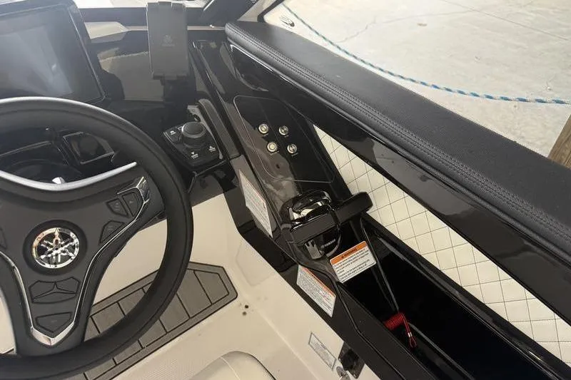 Slide: The Image of Interior view of 2026 Yamaha Boats 275SD dashboard and steering wheel. - 7