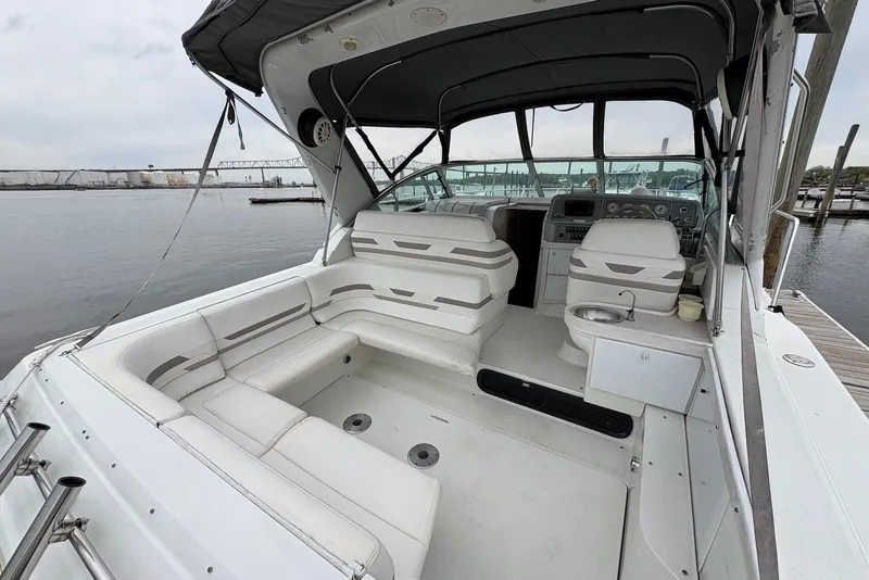 Slide: The Image of 2001 Formula 34 Performance Cruiser interior with seating and helm, docked by the water. - 10