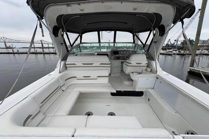 Slide: The Image of 2001 Formula 34 Performance Cruiser interior with white seating, docked at marina. - 11