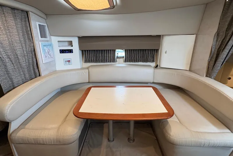 Slide: The Image of 2001 Formula 34 Performance Cruiser interior with beige seating and wooden table. - 13