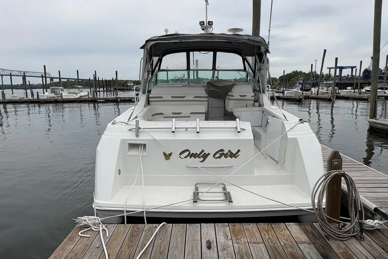 Slide: The Image of 2001 Formula 34 Performance Cruiser docked at marina, rear view with "Only Girl" name. - 2