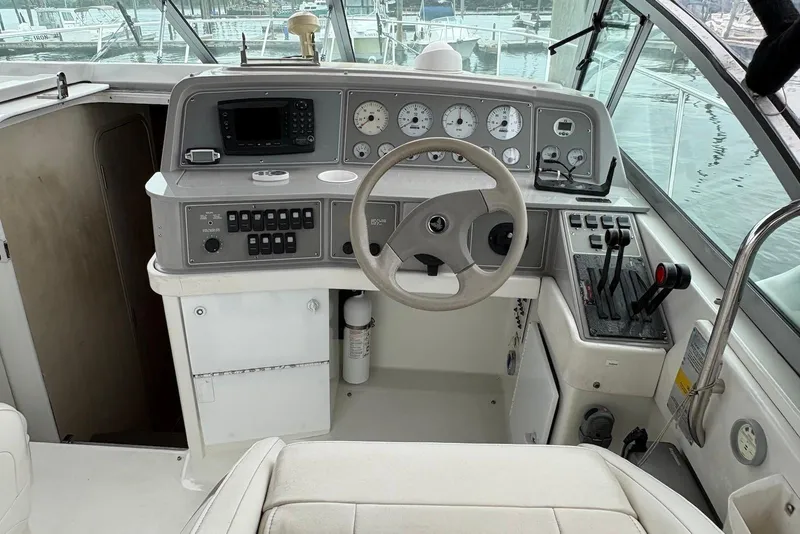 Slide: The Image of 2001 Formula 34 Performance Cruiser helm with gauges, controls, and steering wheel. - 3