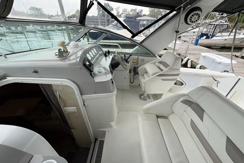 Slide: The Image of 2001 Formula 34 Performance Cruiser cockpit with white seating and control panel at marina. - 5