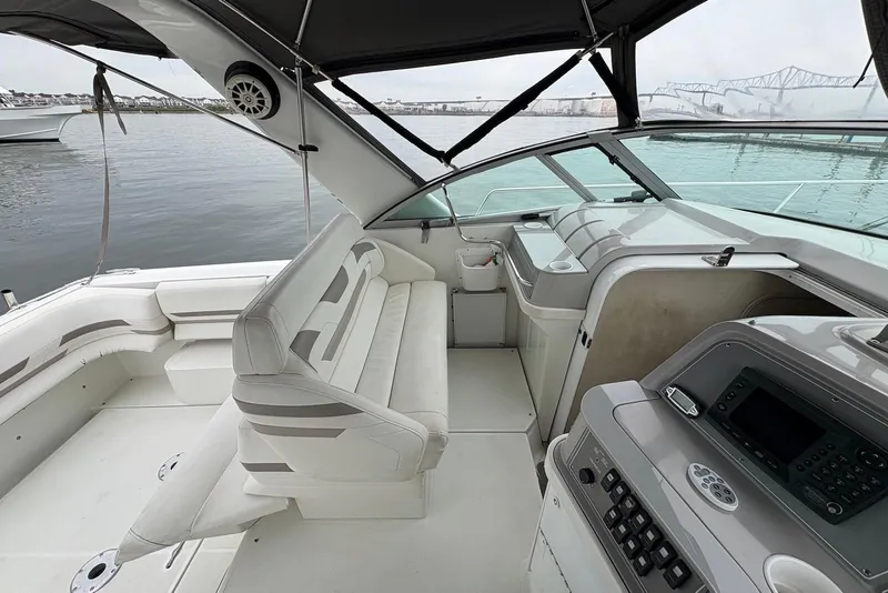 Slide: The Image of 2001 Formula 34 Performance Cruiser interior with seating and control panel, docked by the water. - 6