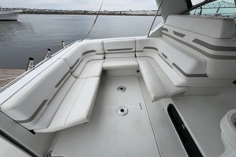 Slide: The Image of 2001 Formula 34 Performance Cruiser interior with white seating, docked by the water. - 9