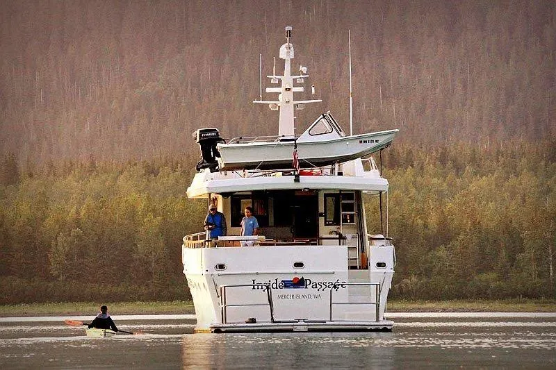 Slide: The Image of 1991 Forbes Cooper Pilothouse Motoryacht on serene water, surrounded by lush forest. - 2