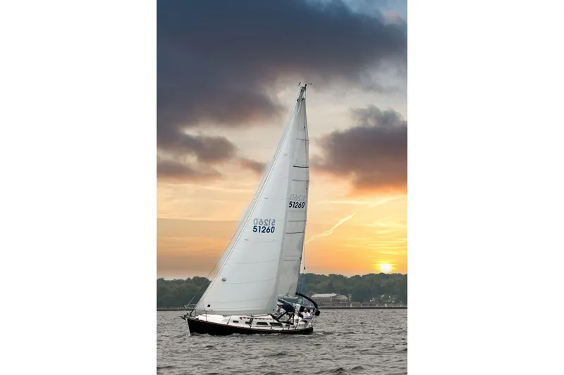 The Image of Sailing yacht Sabre 362, 1994 model, gliding on water at sunset with dramatic sky. - 1