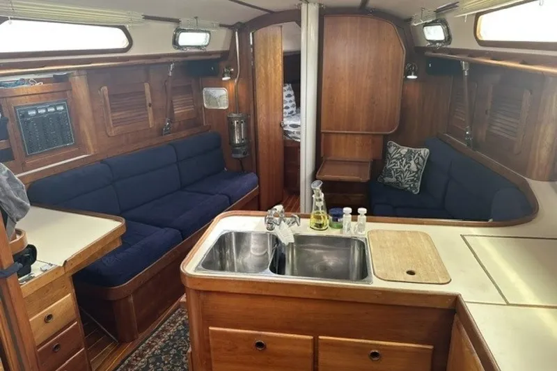 Slide: The Image of Interior of 1994 Sabre 362 sailboat with cozy seating and wooden cabinetry. - 19