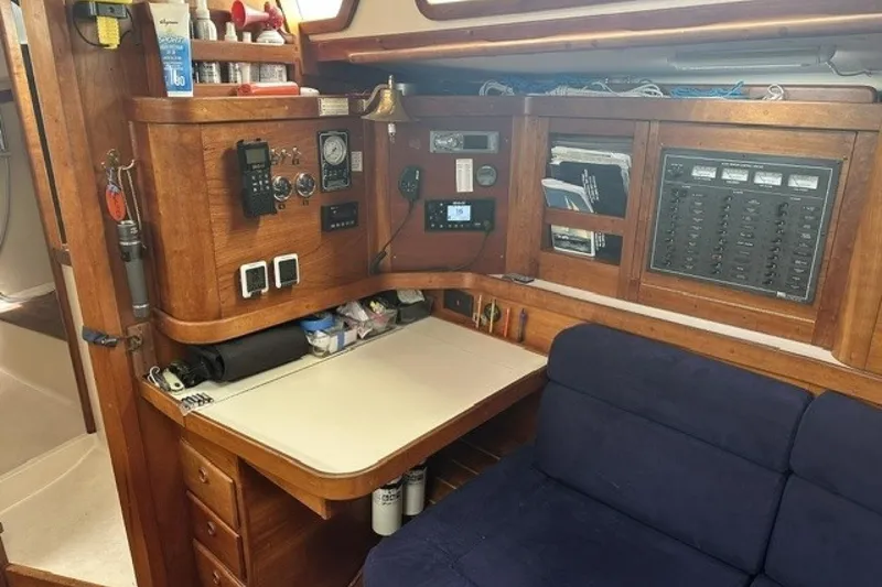 Slide: The Image of Navigation station in a 1994 Sabre 362 sailboat with control panels and seating. - 20
