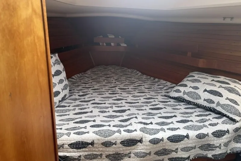 Slide: The Image of Cozy cabin interior of 1994 Sabre 362 sailboat with fish-patterned bedding. - 21