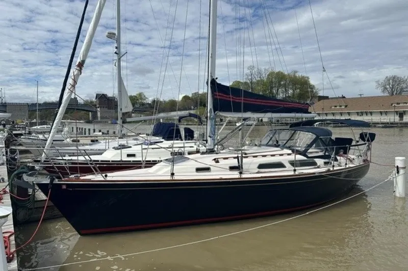 Slide: The Image of 1994 Sabre 362 sailboat docked at a marina under a cloudy sky. - 26