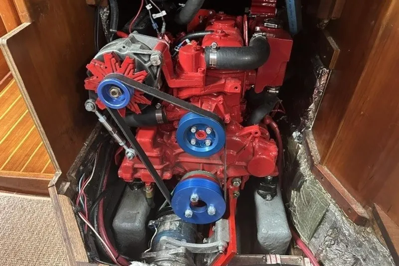 Slide: The Image of Red engine inside a 1994 Sabre 362 boat, featuring blue pulleys and visible wiring. - 27